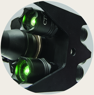 Close view of the twin green lasers of the Zero Convergence aiming system on the disrupter barrel
