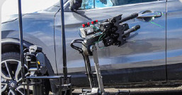 Lance Disrupter mounted on the manipulator arm of a Digital Vanguard robot, aimed at the door of a parked car